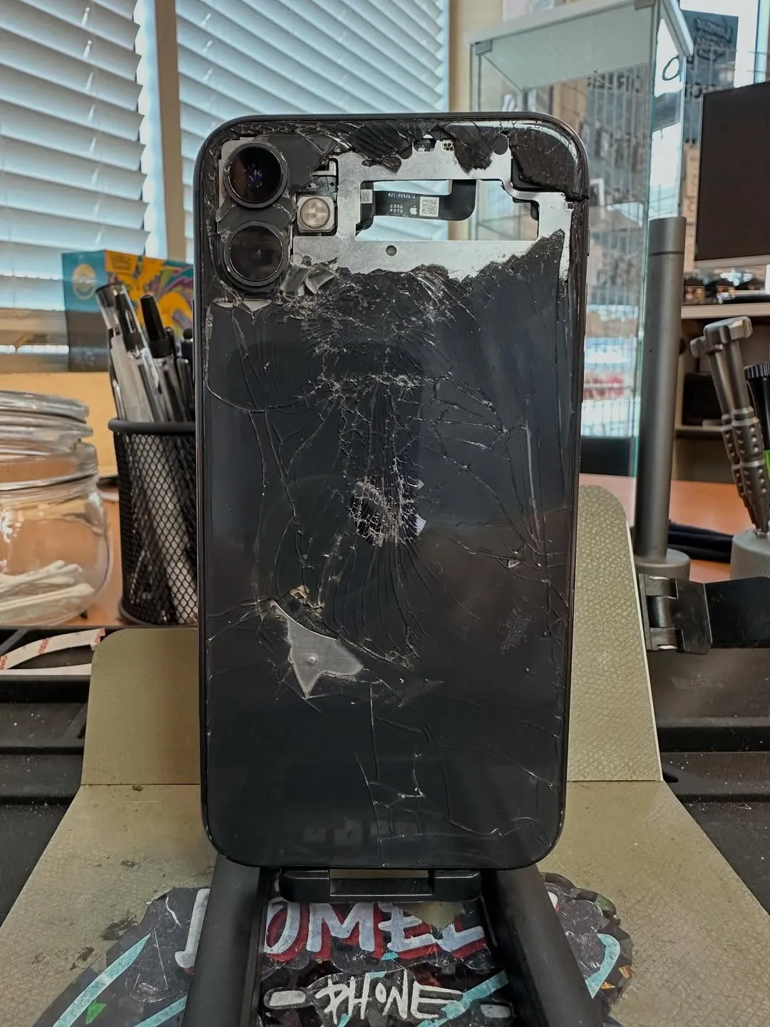 iPhone 11 with shattered back glass before repair