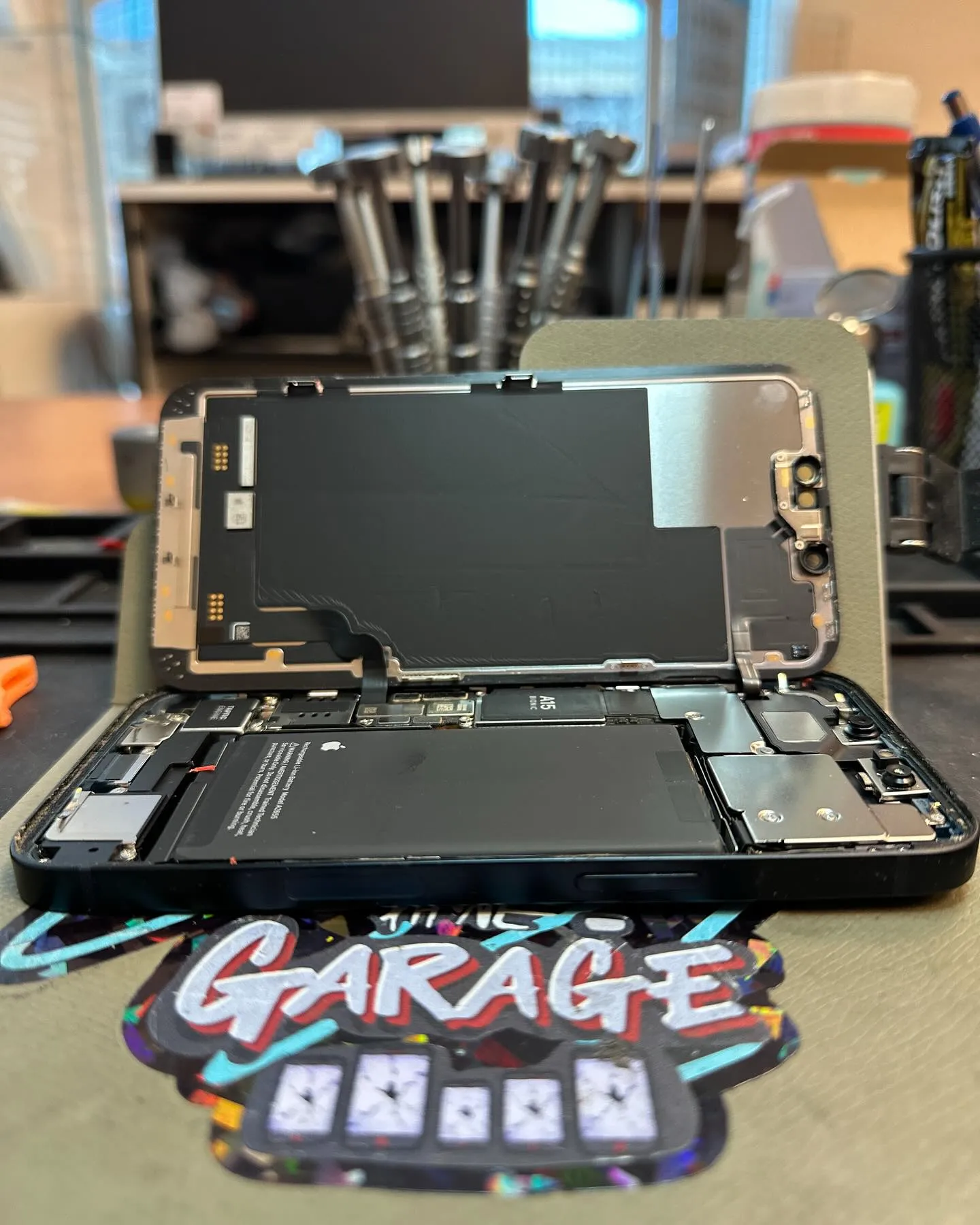 Open iPhone 13 during battery replacement at Lomeli's Phone Garage